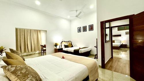 a hotel room with a bed and a living room at Tranquil Resort - Blusalzz Collection, Wayanad - Kerala in Ambalavayal
