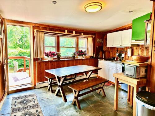 a kitchen with a table and a window and a table at Cozy Hunter Cabins in Hunter