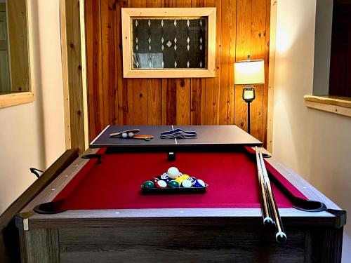 a pool table in a room with a red pool table at Cozy Hunter Cabins in Hunter
