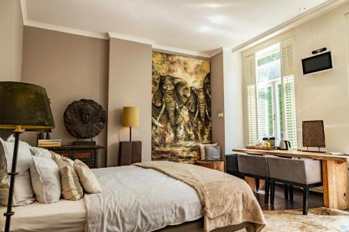 Bouteaque Hotel في ماستريخت: غرفة نوم مع لوحة كبيرة على الحائط