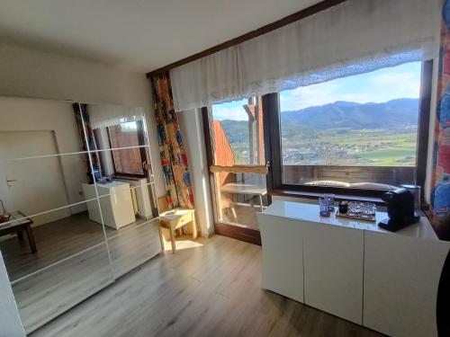 a kitchen with a large window with a view at Herzogberghof in Kindberg