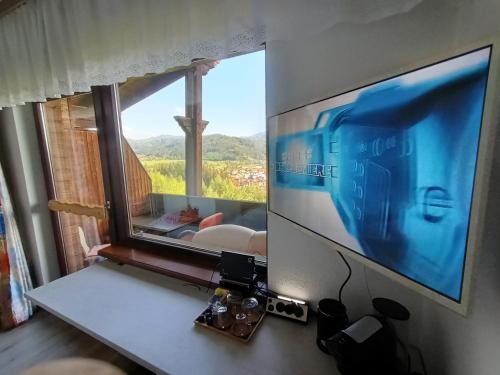 a flat screen tv sitting on top of a table at Herzogberghof in Kindberg