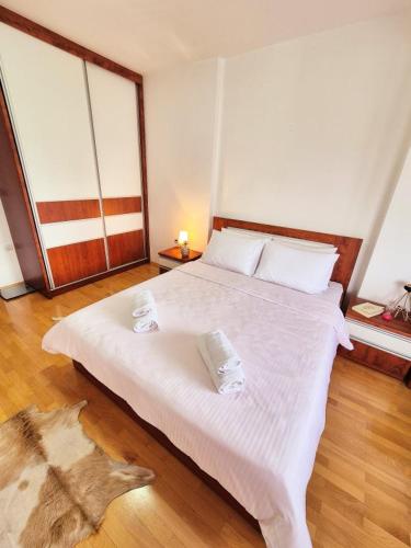 a bedroom with a large white bed in a room at Amsterdam Apartment Strumica in Strumica