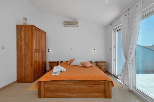 a bedroom with a bed and a large window at Villa Juric 1 in Baška Voda