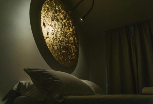a bedroom with a round mirror on the wall at Catania House in Catania