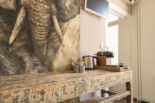 a painting of an elephant on the wall in a kitchen at Bouteaque Hotel in Maastricht