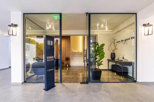 an open glass door in a building with a lobby at Luaz Suites in Volos