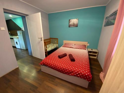 a bedroom with a bed with red polka dots at Guest House Devetaki in Devetaki