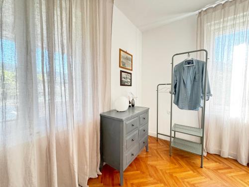 a gray dresser in a room with a window at Casa Faria in Stari Grad