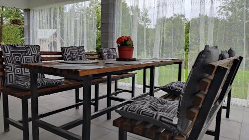 een houten tafel en stoelen op een patio bij Holiday home Dream Bosanska Krupa in Bosanska Krupa