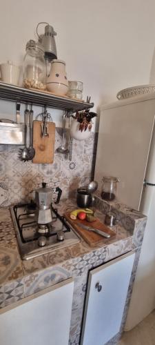 a kitchen with a stove and some pots and pans at Corte Moline in Gallipoli