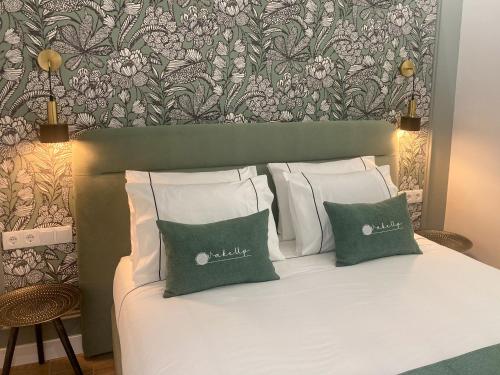 a bed with white pillows and a floral wallpaper at WakeUp - São Francisco in Valença
