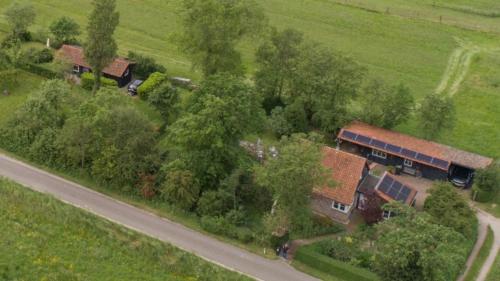 an overhead view of a house with trees and a road at ''Op Stok" in Bergen