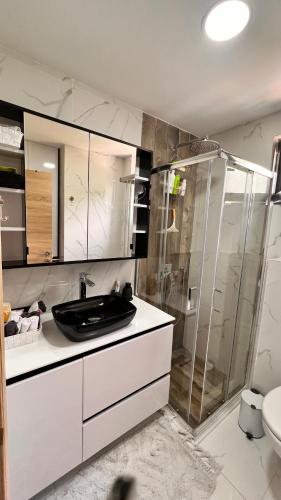 a bathroom with a sink and a glass shower at Kumbor Happy Place in Kumbor