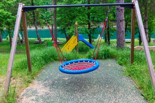 a playground with a blue and red swing at [vista Sibillini] Villa Amici in Verri