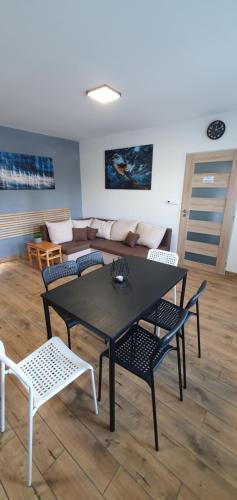 a table and chairs in a living room with a couch at Sauna 32 in Vítkov