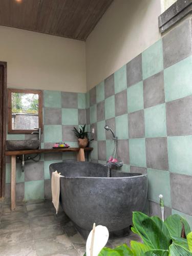 a large bath tub in a room with at Thani Villa Ubud in Ubud
