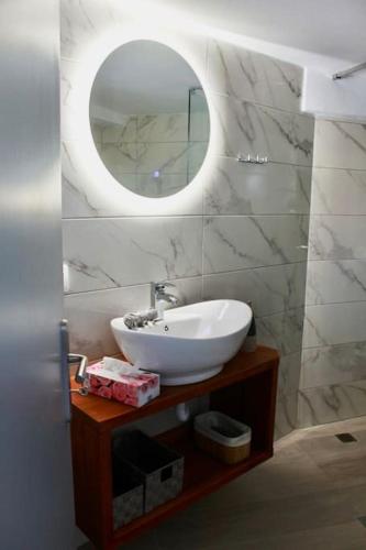 a bathroom with a sink and a mirror at Nikis home in Kalliópi