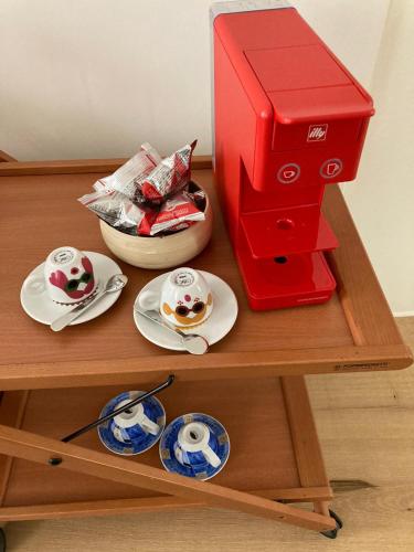 a red espresso machine sitting on top of a table at Diana's luxury guest house in Padova