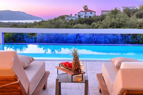 a villa with a view of a swimming pool at Minoas Villas Heated Pool in Kournás