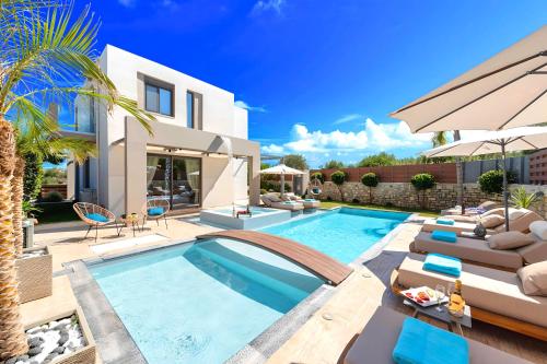 a villa with a swimming pool and a house at Minoas Villas Heated Pool in Kournás