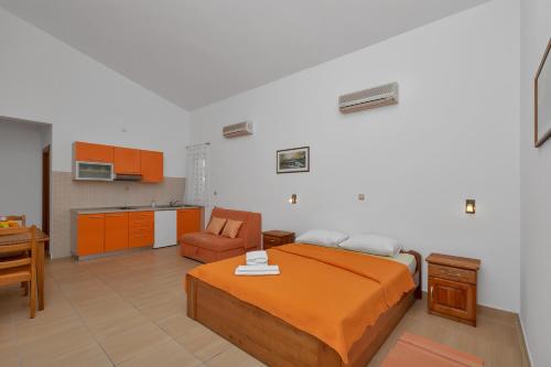 a bedroom with a bed and a chair in it at Villa Juric 1 in Baška Voda
