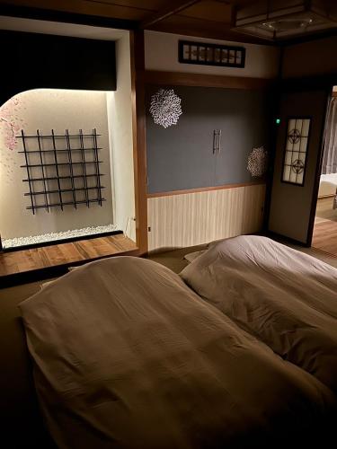 a bedroom with a bed and a window with snow at JaM in Noboribetsu