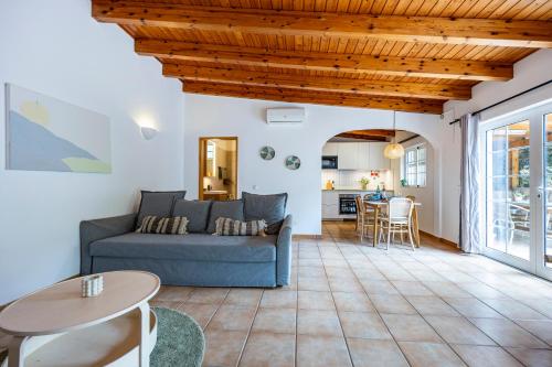 a living room with a couch and a table at Quinta da Liberdade in Luz