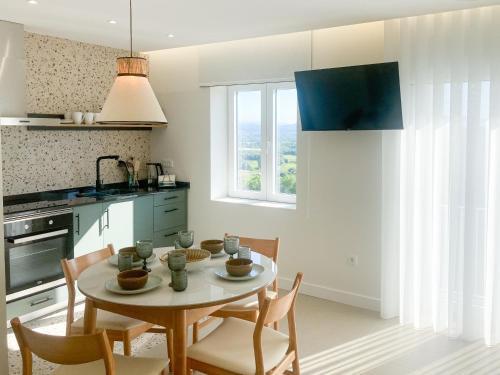 a kitchen with a table and chairs in a kitchen at WakeUp - São Francisco in Valença