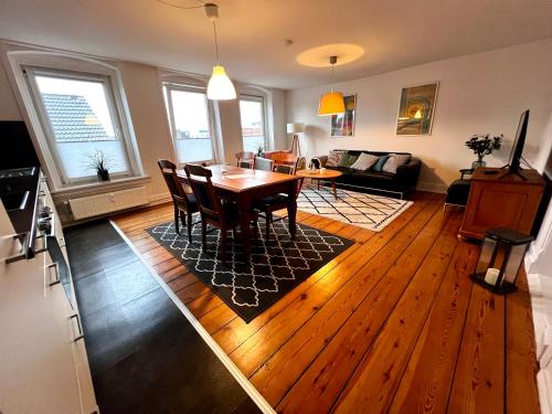 a living room with a table and a dining room at Apartment No.9 in Husum