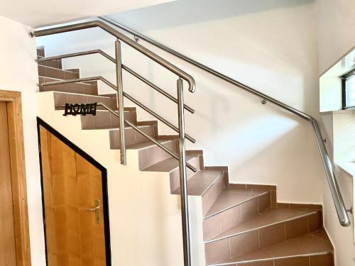 a staircase with steel railings and a glass handrail at Apartman MyHome Travnik in Travnik