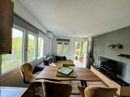 a living room with a table and a couch at G.Tzanis Luxury Apartments in Parga