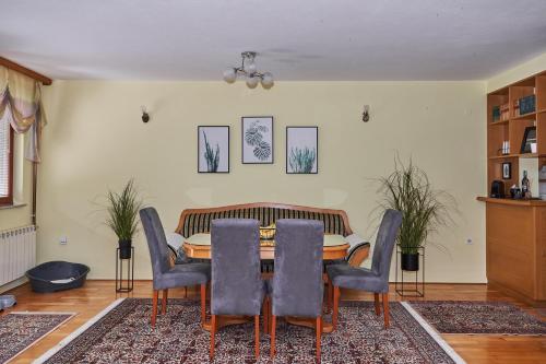 a dining room with a table and chairs at Nanki's Residence in Visoko