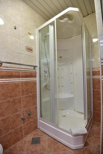 a shower with a glass door in a bathroom at Holiday Home in Komarna