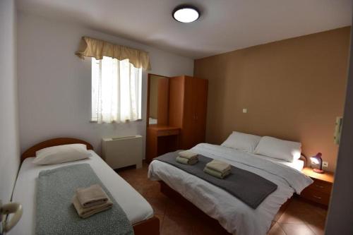 a bedroom with two beds with towels on them at Holiday Home in Komarna