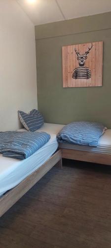 two beds sitting next to each other in a room at Huinerhofje 2 - Vrijstaand met grote omheinde tuin, rust, privacy en nabij bossen in Putten