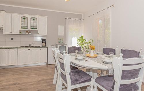 a kitchen and dining room with a table and chairs at Villa Iris in Trbounje