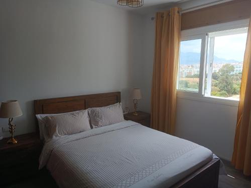 a bedroom with a bed and a large window at The Oxygen 7 in Tetouan