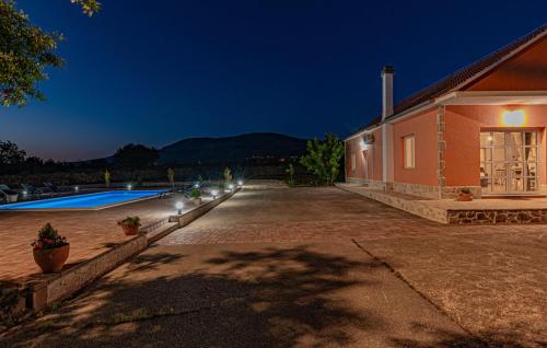 a house with a swimming pool at night at Villa Iris in Trbounje