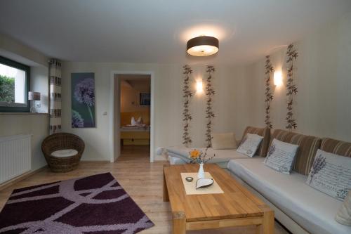 a living room with a couch and a table at Villa Stock Wohnung VS 5 im Souterrain in Heringsdorf