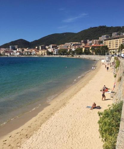 - une plage avec des personnes sur le sable et l'eau dans l'établissement VIEILLE VILLE D AJACCIO de 1 a 4 PERs A 300M DU PORT ET A 15 MN DE LAEROPORT PROCHES DE PLUS BELLES PLAGES ET TTES COMMODITES A PROXIMITE, à Ajaccio