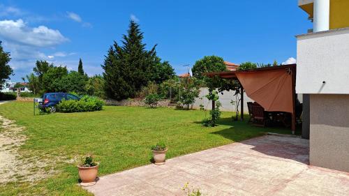 a yard with a tent and a car parked at Villa Antonia in Medulin