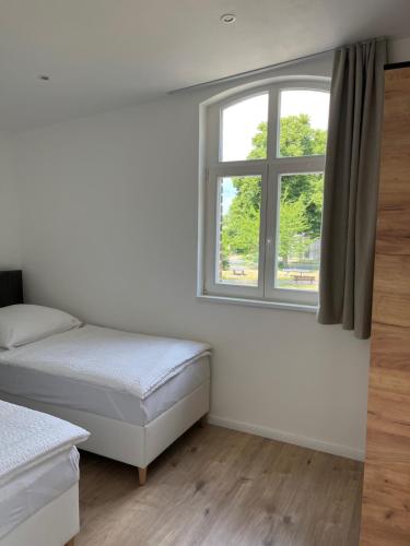 Katil atau katil-katil dalam bilik di Remise 23a - 2Schlafzimmer Unterkunft für 4-köpfige Familie