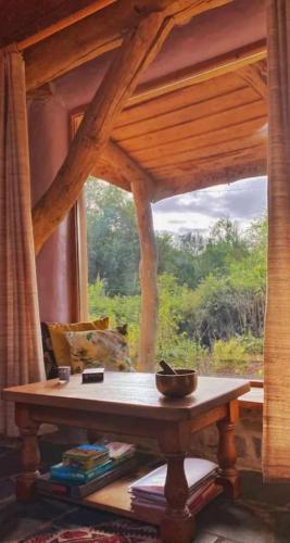 a table in front of a window in a room at Tara vegetarian retreat guesthouse in Carmarthen