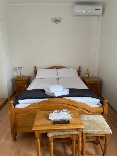 a bedroom with a bed with two shoes on a table at Pensiunea Olimp in Arad