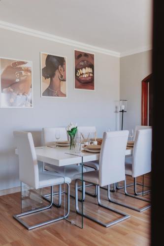 a dining room with a white table and chairs at 3 bedroom apartment Cozy experience Lisbon in Mealhada