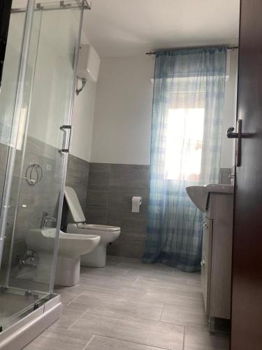 a bathroom with a toilet and a sink and a shower at Nonna Lella in Ripa Teatina