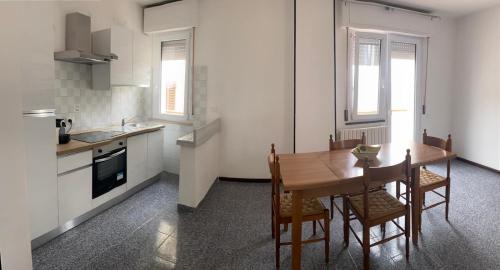 a kitchen with a wooden table and chairs in a kitchen at Nonna Lella in Ripa Teatina