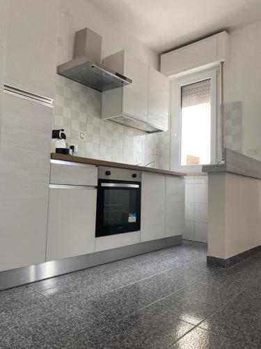 a kitchen with white appliances and a window at Nonna Lella in Ripa Teatina