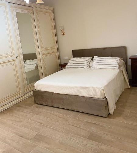a bedroom with a bed and a large mirror at Carmen House3 in Cirò Marina